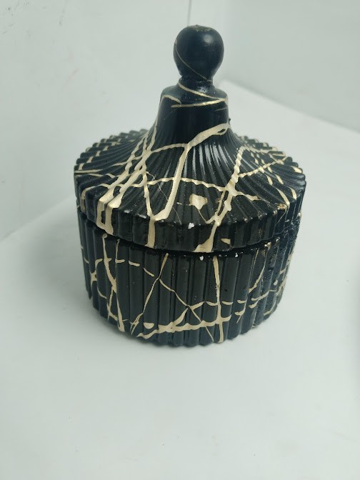 This decorative set consists of handcrafted art pieces including a round tray, a