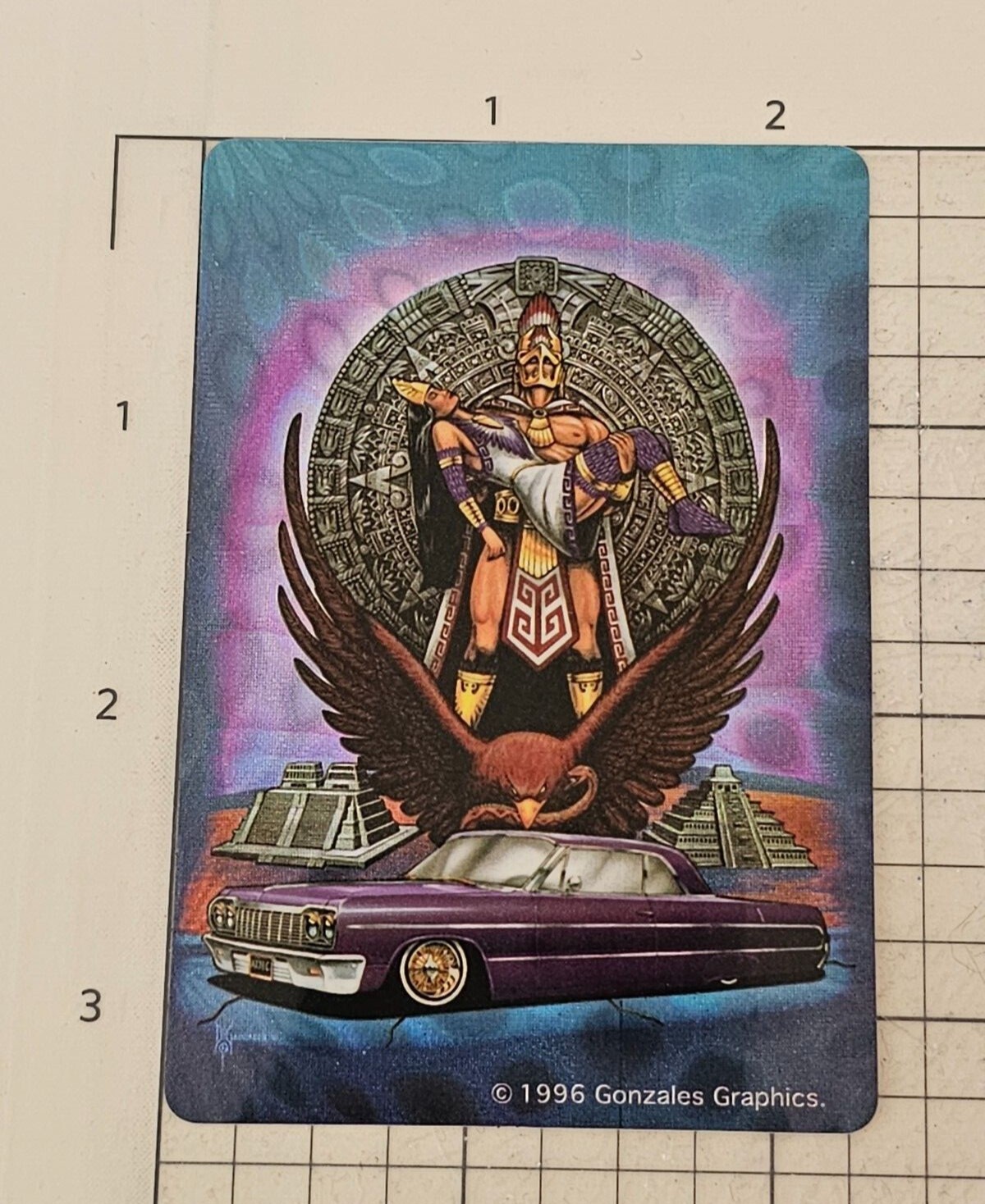 Aztec man holding a woman. Eagle and a purple lowrider sticker by Gonzales Graph