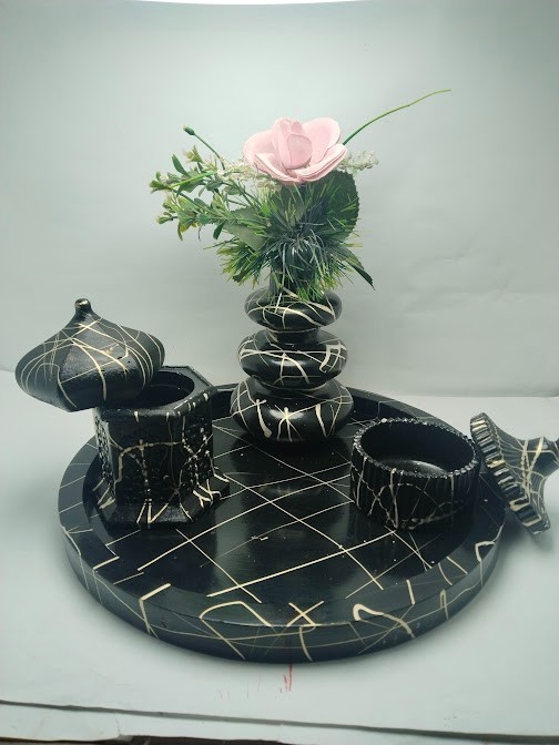 This decorative set consists of handcrafted art pieces including a round tray, a