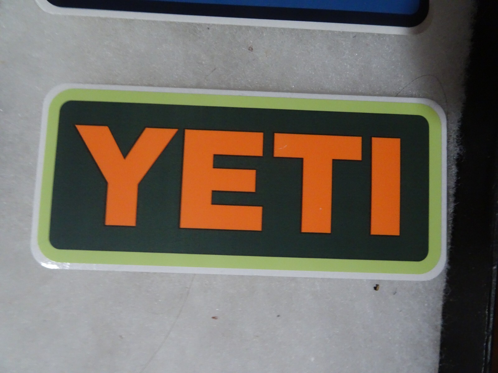 Authentic YETI Decal Sticker black and orange 4" x 1.75"