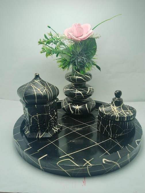 This decorative set consists of handcrafted art pieces including a round tray, a