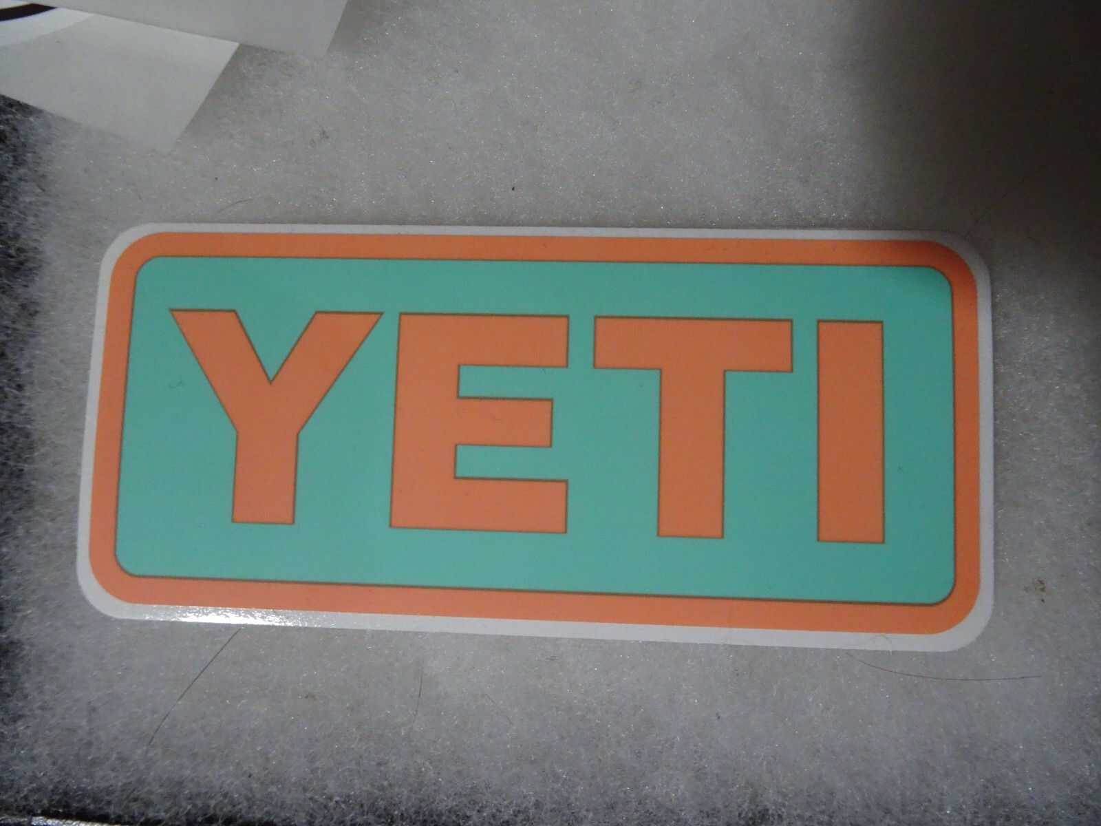 Authentic YETI Decal Sticker aqua and orange 4" x 1.75"