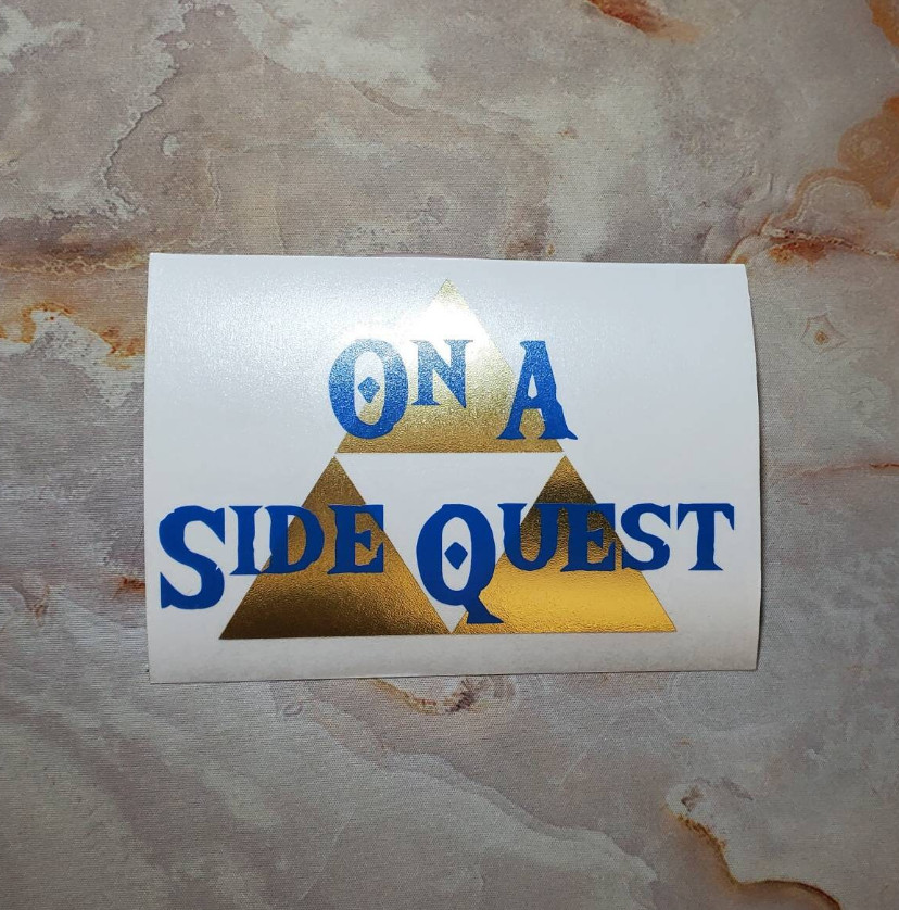 On A Side Quest Decal with Brushed Metallic Gold Vinyl 6"