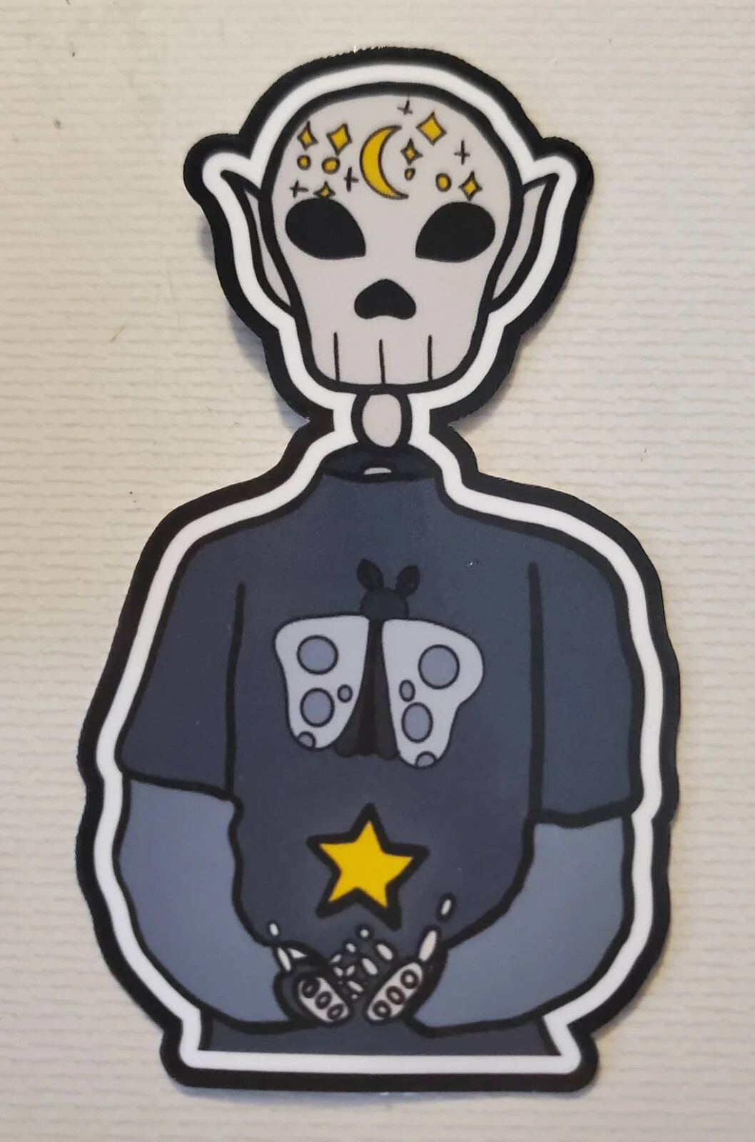 Handmade "Skeleton in Moth Shirt" die cut sticker. See description!