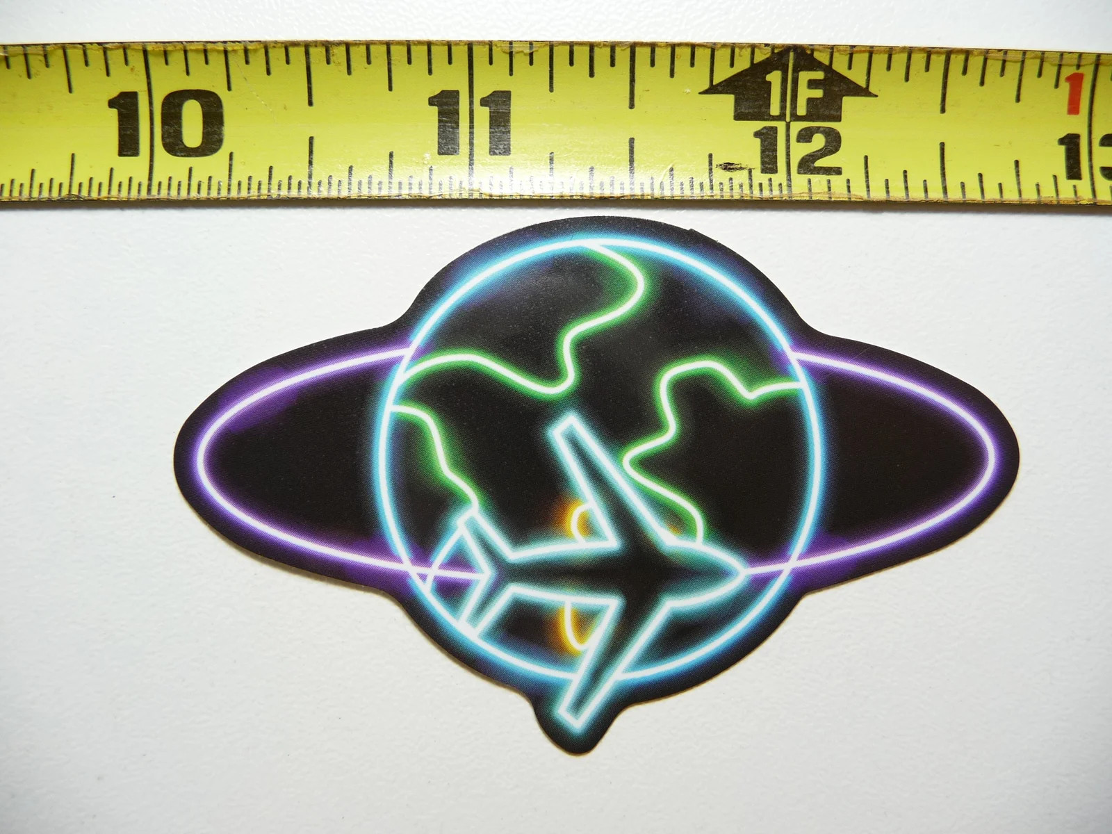 AIRPLANE CIRCLING THE GLOBE SMALL STICKER DECAL NEON STYLE FUN FUNNY