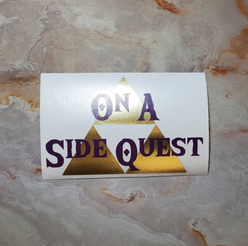 On A Side Quest Decal with Brushed Metallic Gold Vinyl 6"