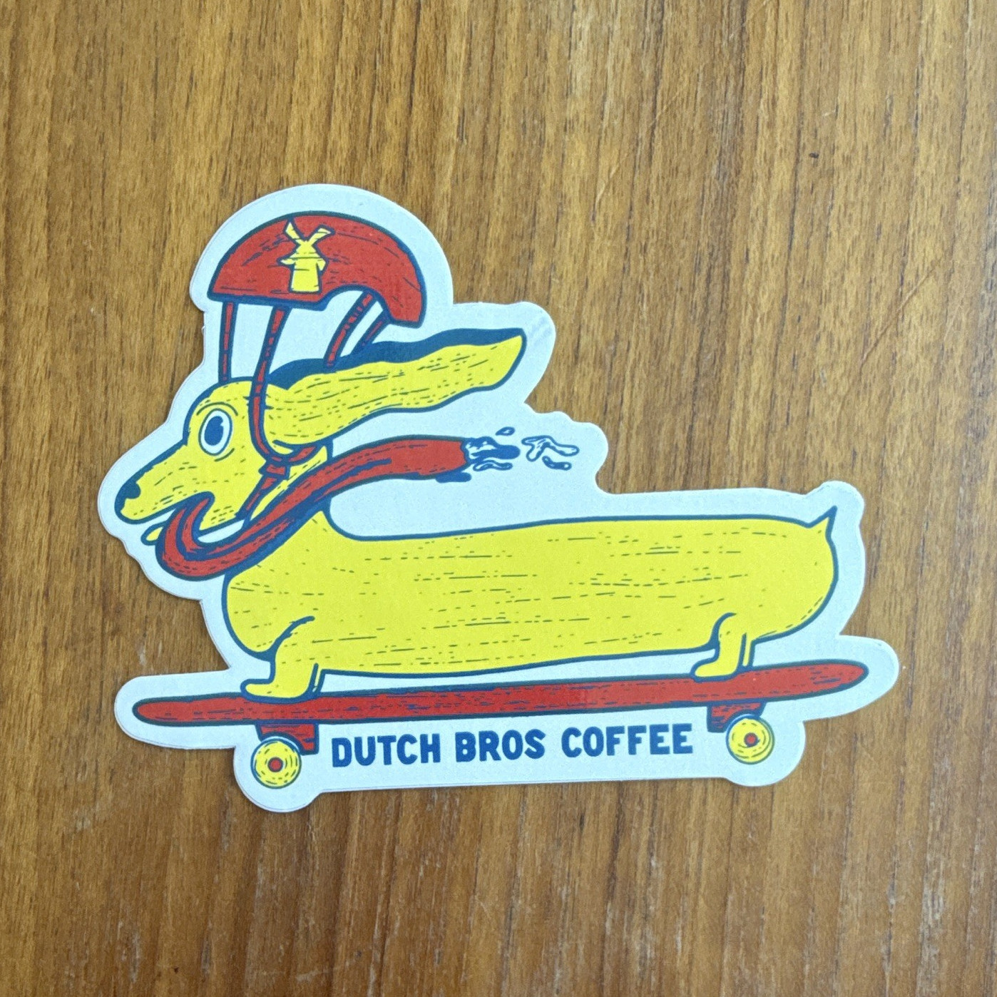 Dutch Bros Coffee Dachshund on Skateboard Yellow and Red Sticker, Coffee & Tea