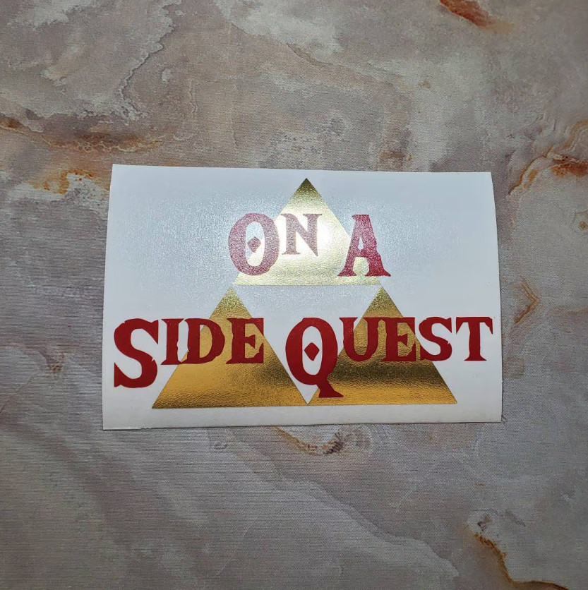 On A Side Quest Decal with Brushed Metallic Gold Vinyl 6"