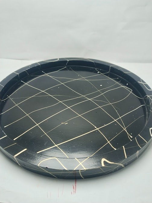 This decorative set consists of handcrafted art pieces including a round tray, a