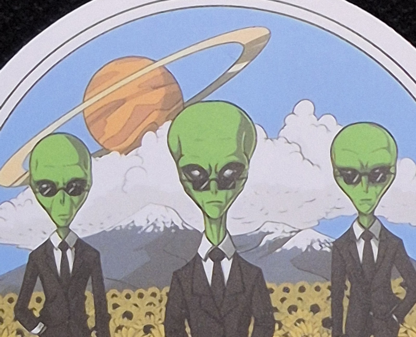 Men In Black Alien UFO UAP Round Decal Sticker. Approximately 2"