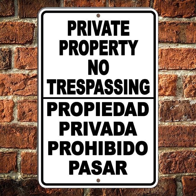 Private property no trespassing english spanish sign metal aluminum surveillance
