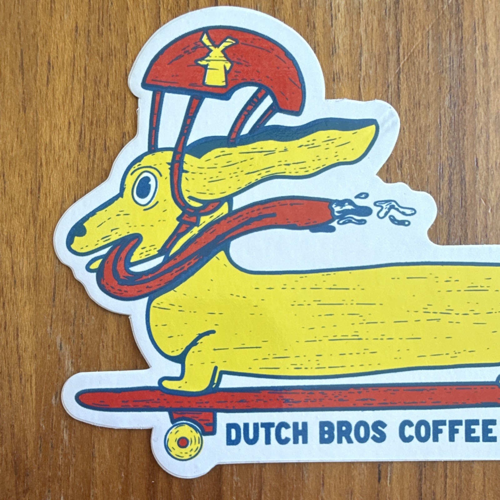 Dutch Bros Coffee Dachshund on Skateboard Yellow and Red Sticker, Coffee & Tea